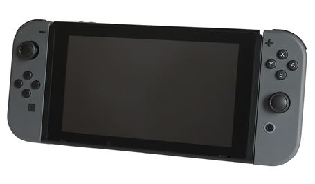 The black Nintendo Switch on a white background towards the viewer